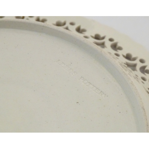 64 - A Leeds Pottery creamware plate with a pierced border. Impressed marks under. Approx. 8 1/4