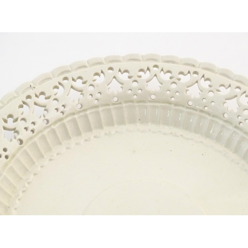 64 - A Leeds Pottery creamware plate with a pierced border. Impressed marks under. Approx. 8 1/4