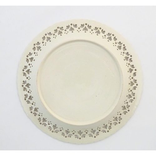 64 - A Leeds Pottery creamware plate with a pierced border. Impressed marks under. Approx. 8 1/4