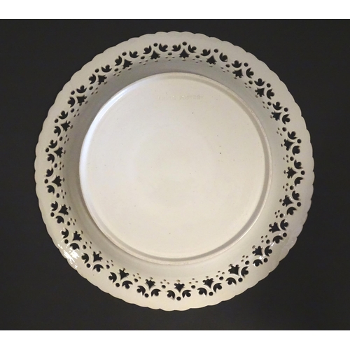 64 - A Leeds Pottery creamware plate with a pierced border. Impressed marks under. Approx. 8 1/4