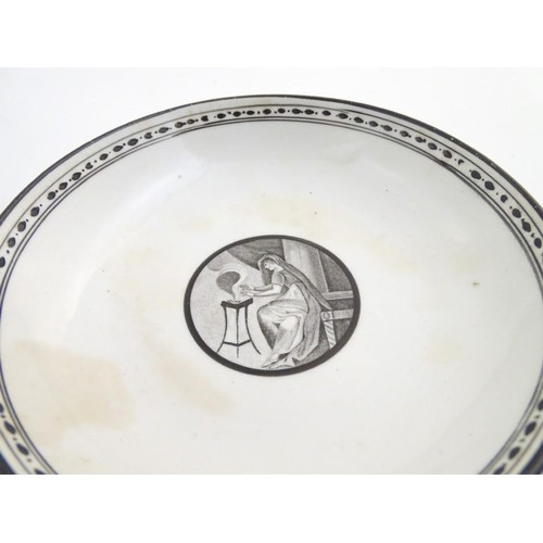 72 - A 19thC tea bowl and saucer, decorated with monochrome roundels depicting a seated man warming by a ... 