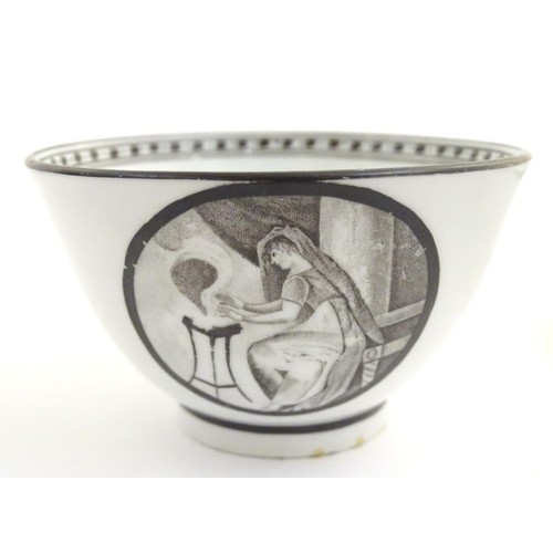 72 - A 19thC tea bowl and saucer, decorated with monochrome roundels depicting a seated man warming by a ... 