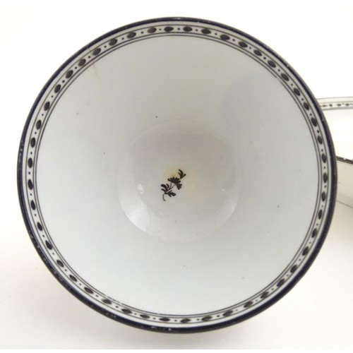 72 - A 19thC tea bowl and saucer, decorated with monochrome roundels depicting a seated man warming by a ... 