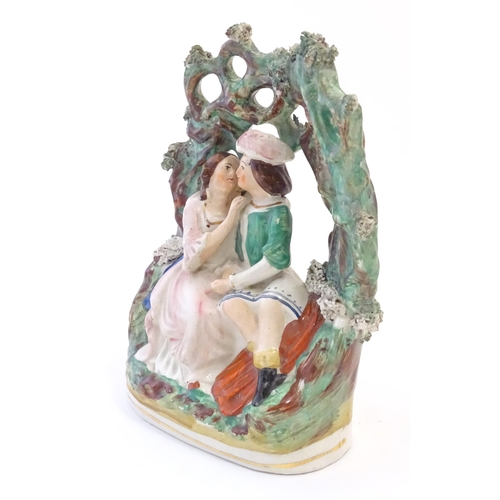 80 - A Victorian Staffordshire pottery flat back figural group depicting Romeo and Juliet within a foliat... 