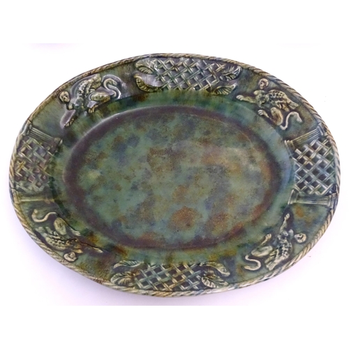 93 - A quantity of Continental majolica wares with a mottled green glaze comprising a serving dish of ova... 