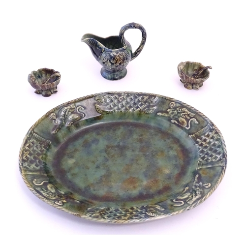 93 - A quantity of Continental majolica wares with a mottled green glaze comprising a serving dish of ova... 