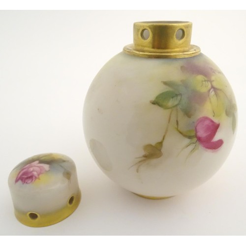 130 - An early 20thC Royal Worcester pot pourri and cover of globular form, with rose decoration. Bears si... 