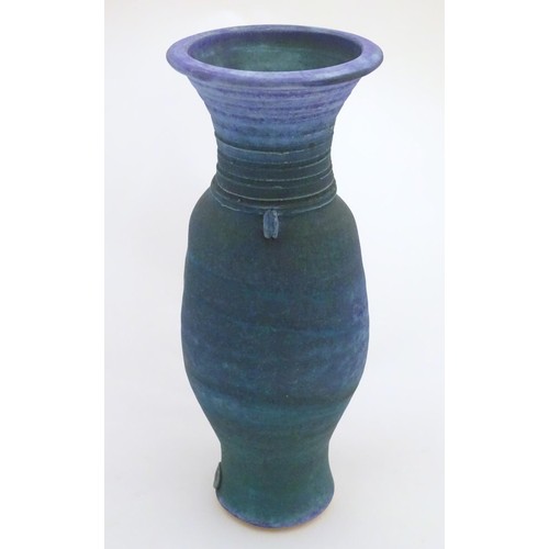 164 - A 20thC studio pottery barium glaze vase by Simon Shaw, with a bulbous body and a flared rim, the ne... 