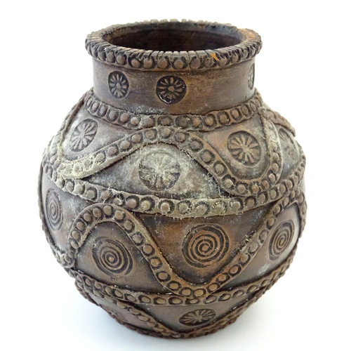 168 - A studio pottery terracotta vase of bulbous form with impressed rosette detail and banded decoration... 