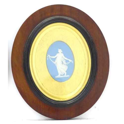 188 - A pair of 19thC Wedgwood jasperware blue and white oval plaques depicting classical maidens, one wit... 