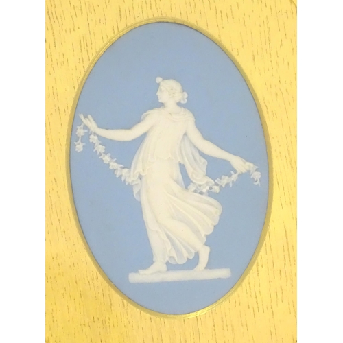 188 - A pair of 19thC Wedgwood jasperware blue and white oval plaques depicting classical maidens, one wit... 