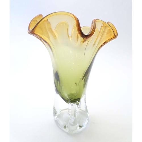 244 - A studio glass vase with amber flared rim and body on a open clear glass base. Approx 11