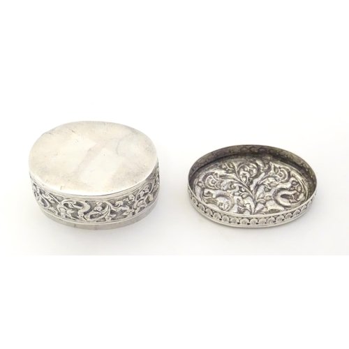 372 - A Continental white metal pot and cover of oval form with embossed decoration. Approx. 2 1/4