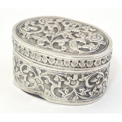 372 - A Continental white metal pot and cover of oval form with embossed decoration. Approx. 2 1/4