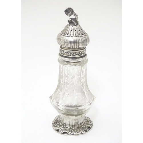 384 - A Continental cut glass pepper pot engraved floral and foliate detail and silver mounts, marked Ster... 