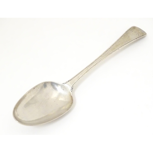 470 - A 19thC silver feather edge tablespoon, hallmarked London 1780 maker John Lambe. Approx 8 1/2