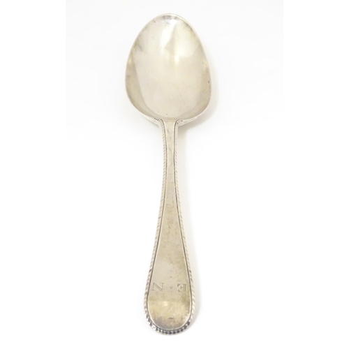 470 - A 19thC silver feather edge tablespoon, hallmarked London 1780 maker John Lambe. Approx 8 1/2