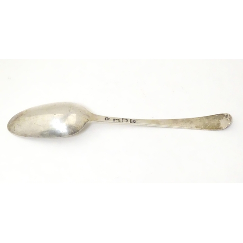 470 - A 19thC silver feather edge tablespoon, hallmarked London 1780 maker John Lambe. Approx 8 1/2