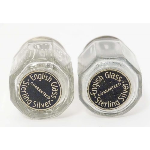 474 - A cut glass salt and pepper pots with silver tops, together with two Mexican silver small salt and p... 