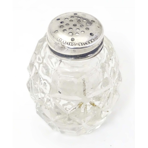 490 - A glass pepper pot with lid marked Sterling Silver 2