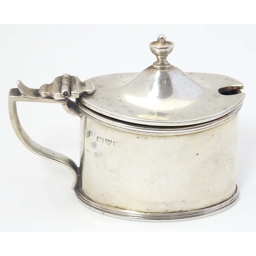 499 - A silver mustard pot of neo classical design with blue glass liner. Hallmarked Chester 1902 maker Ha... 