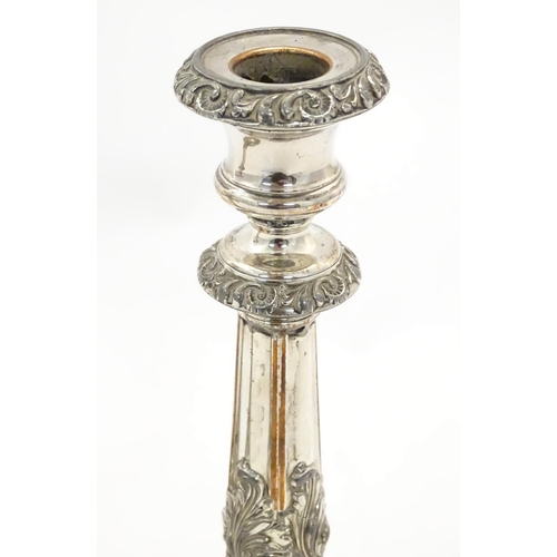 545A - A pair of silver plate candlesticks with acanthus scroll decoration. Approx 9