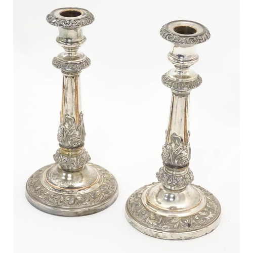 545A - A pair of silver plate candlesticks with acanthus scroll decoration. Approx 9