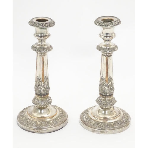 545A - A pair of silver plate candlesticks with acanthus scroll decoration. Approx 9