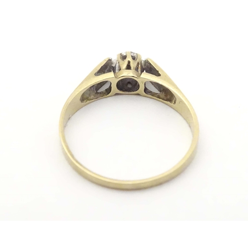 584A - A 9ct gold ring set with central diamond. Ring size approx. J 1/2