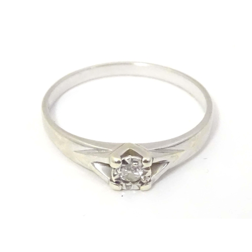 599 - A 9ct white gold ring set with diamond solitaire. the ring approx size L