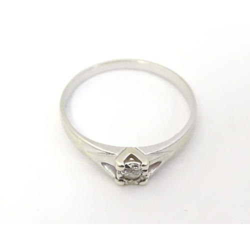 599 - A 9ct white gold ring set with diamond solitaire. the ring approx size L