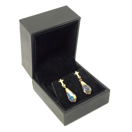 648A - A pair of 9ct gold drop earrings set with facet cut stones. Approx. 1