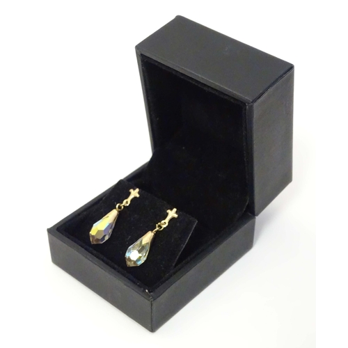 648A - A pair of 9ct gold drop earrings set with facet cut stones. Approx. 1