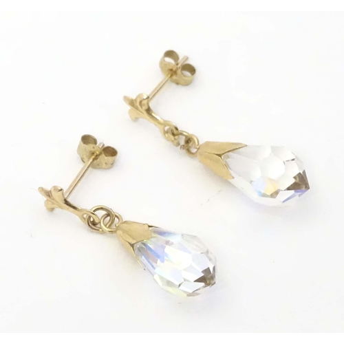 648A - A pair of 9ct gold drop earrings set with facet cut stones. Approx. 1