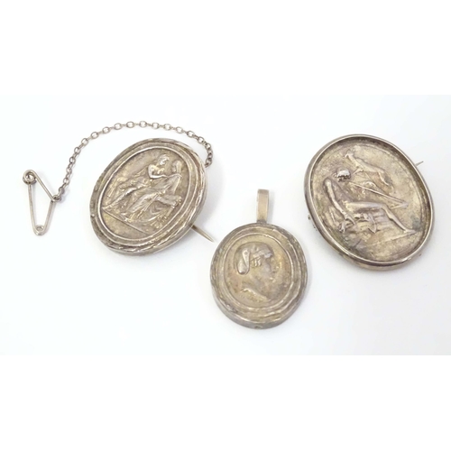 725 - Two white metal brooches of oval form set with various classical scenes together with a white metal ... 