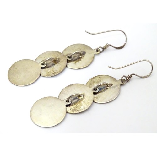 726 - A pair of .925 silver and white metal pendant earrings with three circular discs. Approx. 2