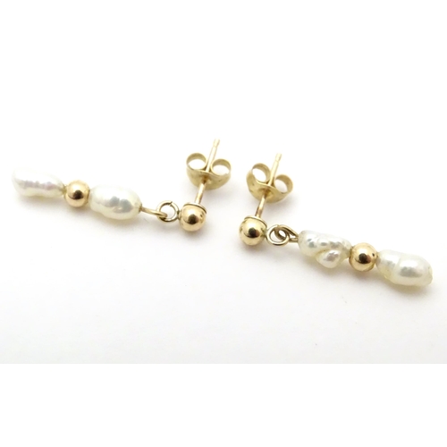 732 - A pair of yellow metal drop earrings set with pearls, together with a pair of screw stud earrings (2... 