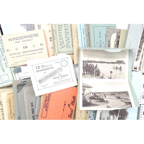 962 - A quantity of early 20thC souvenir photograph booklets containing black and white snapshots of vario... 