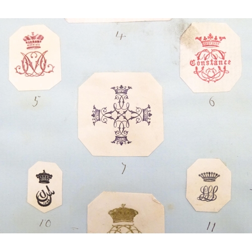 967 - A late 19th / early 20thC album / scrapbook containing various printed / embossed paper monograms, p... 