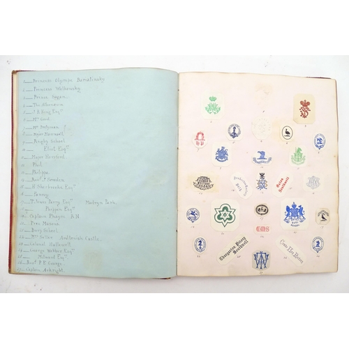 967 - A late 19th / early 20thC album / scrapbook containing various printed / embossed paper monograms, p... 