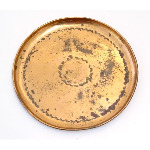 1003 - An Arts & Crafts Newlyn School copper dish / charger of circular form with lobed banded decoration. ... 