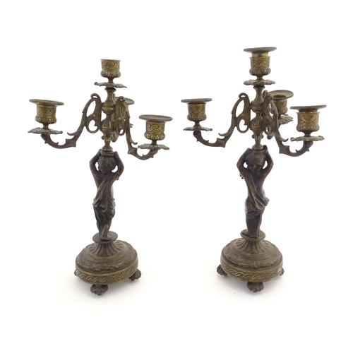 1005 - Two 19thC cast metal table candelabra / candelabrum the central bronze columns form as cherubs holdi... 