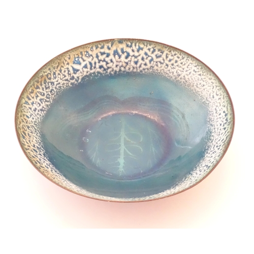 1007 - A 20thC blue enamel bowl by Edward Winter, with stylised foliate decoration. Signed under. Approx. 2... 