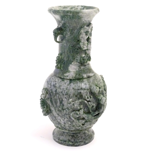 1030 - An Oriental jade coloured soapstone vase of three sectional baluster form decorated with stylised dr... 