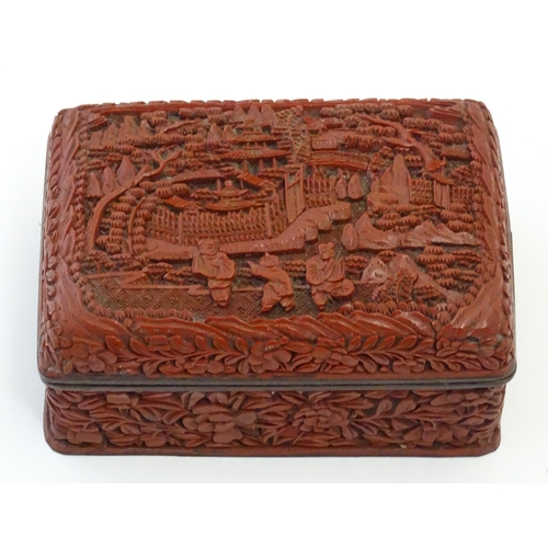 1038 - A Chinese cinnabar lacquer lidded box, the lid with carved detail depicting a landscape scene with t... 