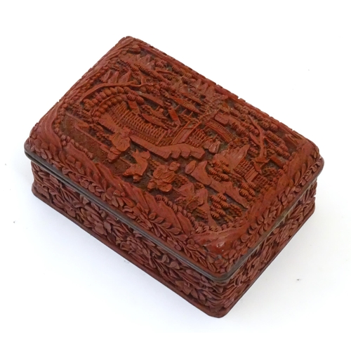 1038 - A Chinese cinnabar lacquer lidded box, the lid with carved detail depicting a landscape scene with t... 