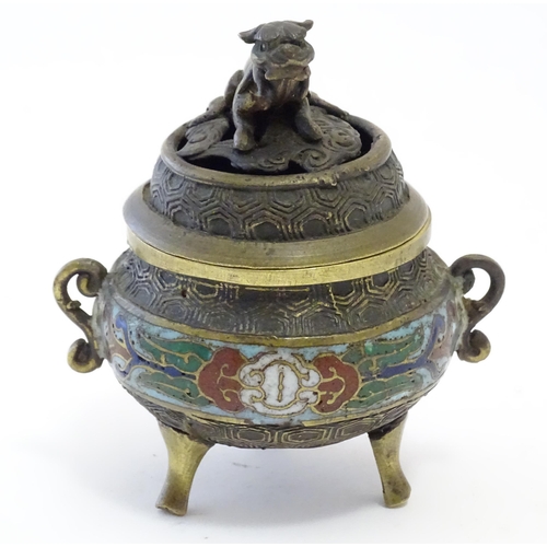 1045 - A Chinese cast brass three footed lidded censer, the body with twin handles and banded enamel detail... 