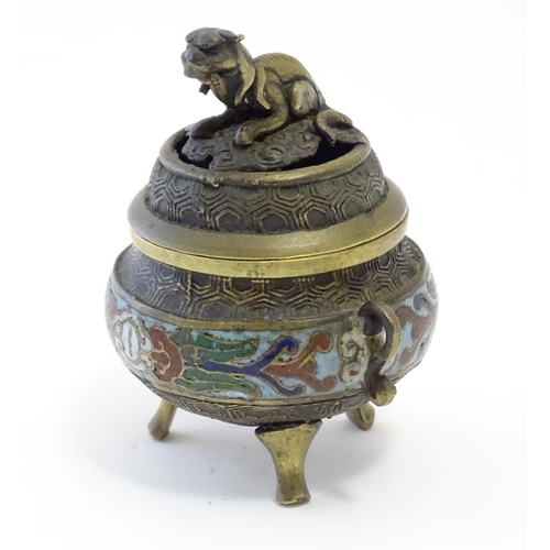 1045 - A Chinese cast brass three footed lidded censer, the body with twin handles and banded enamel detail... 