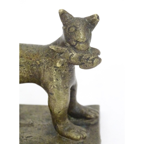 1052 - An 18th / 19th century naive bronze model of a standing cat with a fish, on a rectangular base. Appr... 