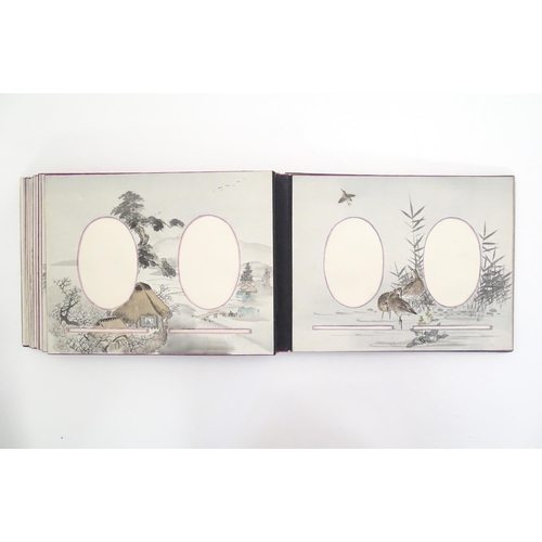 1054 - A Japanese photograph album with lacquered boards, the cover decorated with figures travelling by ha... 